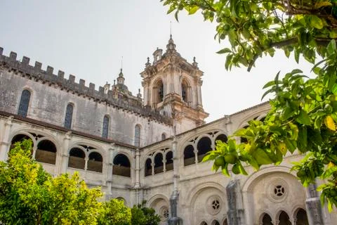 Low-angle shot of the Alcobaca Monastery from the cloister garden. Natural Stock Photos