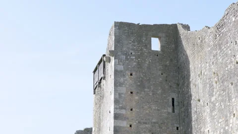 Low-angle shot of an ancient stone fortress tower with a window opening against  Stock Footage 336134141