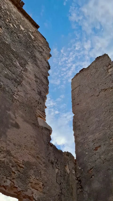 Low angle shot of ancient stone wall ruins with a wooden beam structure agai Stock Footage 344908347