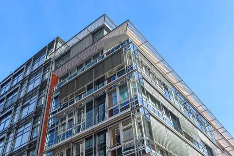 Low angle shot of an angular modern glass building in Kiel, Germany Fotos Stock