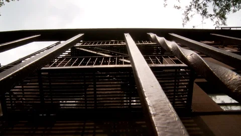 Low angle shot of apartment building fire escape and railings, day. Video stock 110810672