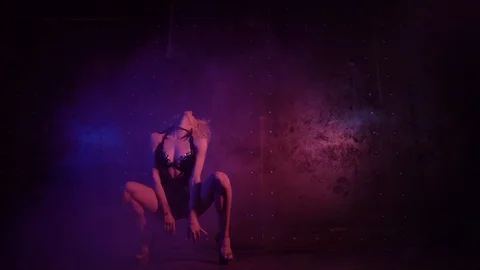 Low angle shot of attractive young woman in lingerie dancing in a dark room, ste Stock Footage 93674766