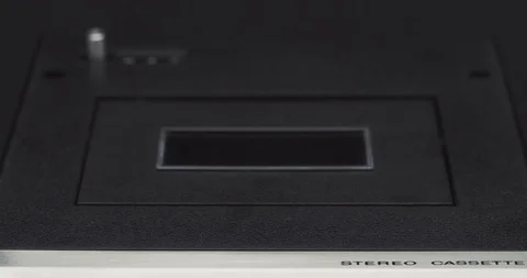 Low angle shot of a audio cassette tape being ejected and revealing magnetic Видео 121188858