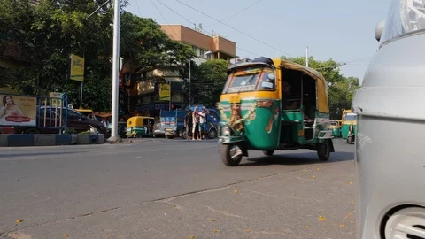 Low angle shot of auto rickshaws driving on busy street in Kolkata city Stock Footage 145042168