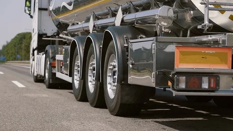 Low angle shot of the back of a driving gasoline tanker truck Stock Footage 126093229