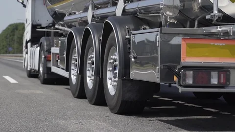 Low angle shot of the back of a driving gasoline tanker truck Stock Footage 128631010