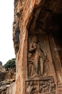 Low angle shot of badami cave 3 ,with carved statue of lord trivikrama . Stock Photos