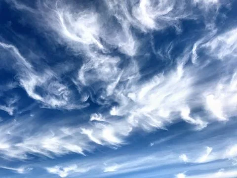 Low angle shot of the beautiful patterns of white clouds in the blue sky Stock Illustration