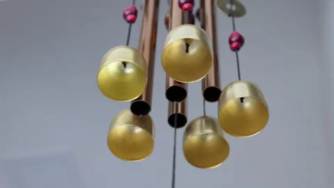 Low angle shot of a beautiful wind chime hanged on the roof, moving in the wind Stock Footage 148759151