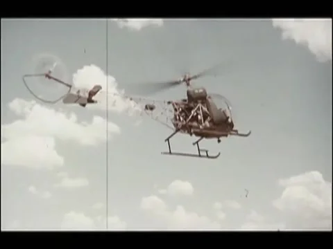 Low angle shot of  Bell H-13 Sioux helicopter flying in sky, 1970s Video stock 65860670