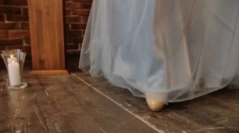 Low angle shot of brides creamy shoes. Woman walks towards the camera in slow Stock Footage 61966990