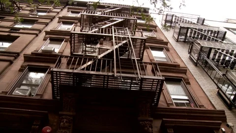 Low angle shot of brownstone apartment building in East Village, Manhattan, day. Stock-Footage 110810663
