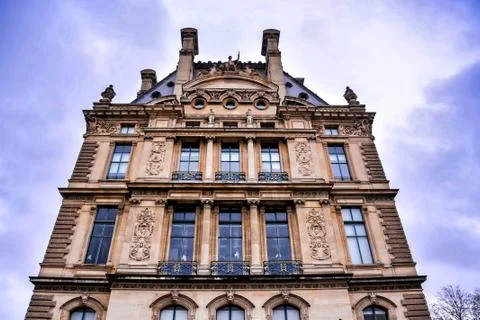 Low angle shot of a building under a cloudy sky in Paris, France Stock Photos