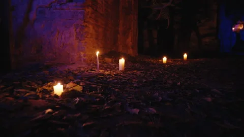 In a low-angle shot, camera fly around a magical place with candles.outdoors Vídeo Stock 259789393
