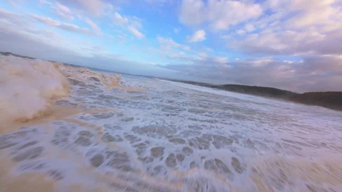 Low angle shot captures powerful ocean waves washing ashore Stock Footage 344675767