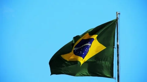 A low-angle shot captures the vibrant green and yellow national flag of Brazil 스톡 동영상 346115978