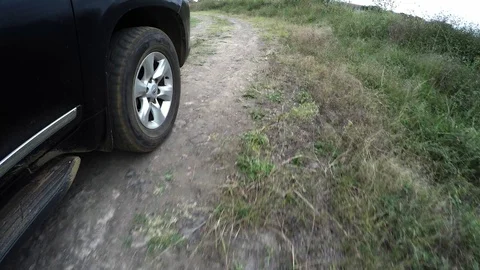 Low angle shot of car driving on a grassy dirt path in Africa Video stock 106963807