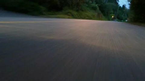 Low angle shot of car driving down deserted windy road Stock Footage 154655947