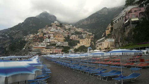 Low angle shot of chairs and umbrellas on positano beach Stock Footage 137090725