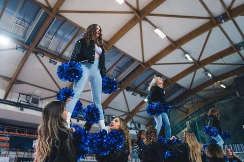 Low-angle shot of cheerleaders doing an extension stunt. Sport concept. Stock Photos