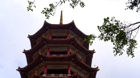 Low angle shot of Chinese tower pagoda temple through tree branches Stock Footage 91123002