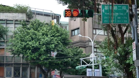 Low angle shot of city traffic light turns to red for pedestrian walking Stock Footage 86174099