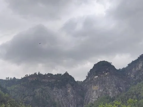 Low angle shot of cliffs under a stormy sky in Paro, Bhutan Stock Photos