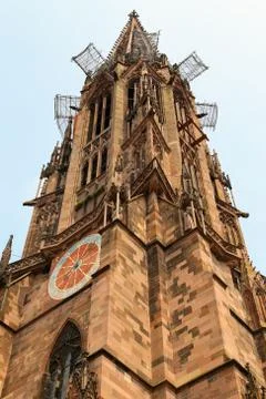 Low angle shot of the clock tower of Freiburg cathedral Stock Photos