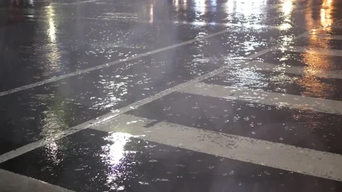Low angle shot of commuters and cars passing by road at rainy night Video stock 167507634