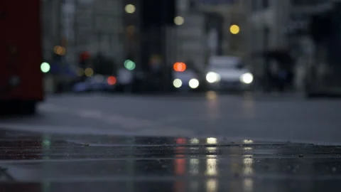 Low Angle Shot Of Commuters And Cars Passing By Road At Rainy Night Stock Footage 255285164