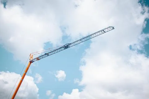 Low angle shot of a construction crane under a cloudy sky Stock Photos