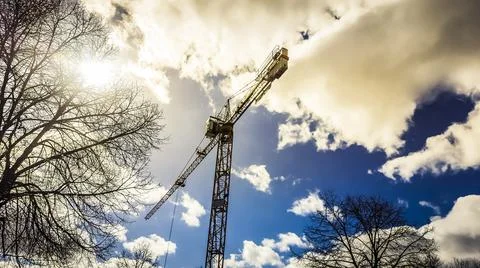 Low angle shot of a construction crane captured on a cloudy Stock Photos