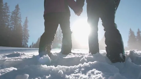 Low angle shot of couple walking in high snow on a beautiful snowy day Vídeo Stock 85077592
