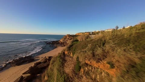 Low angle shot of crashing ocean waves near rocky shore Stock Footage 344563829