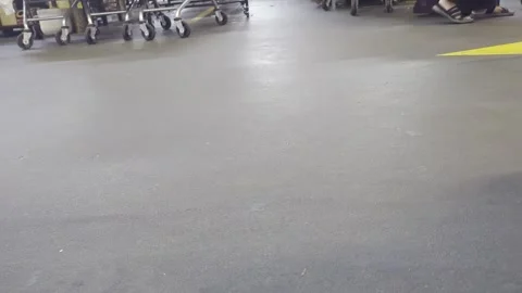 Low Angle Shot of Customers Walking and Pushing Shopping Carts in Supermarket Stock Footage 330574370
