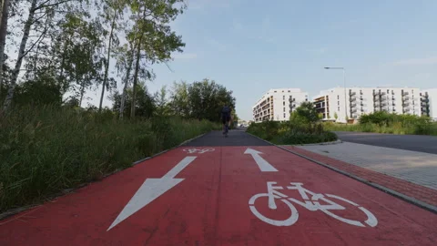 Low angle shot of a cyclist riding past a painted bicycle lane symbol on a .. Stock Footage 339078786