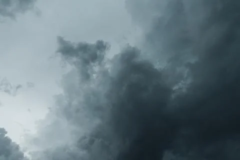 A low-angle shot of dark, heavy storm clouds gathering Stock Photos