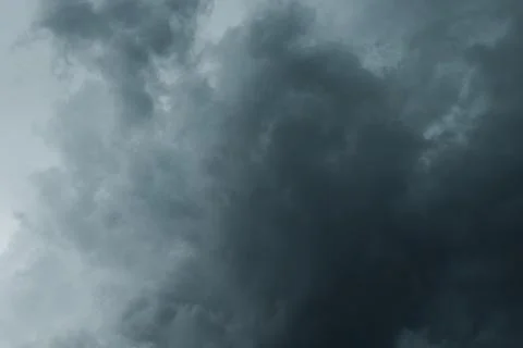 A low-angle shot of dark, heavy storm clouds gathering Stock Photos