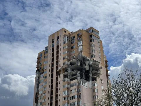 Low angle shot of destroyed by bomb shelling apartment house in the country w Stock Photos