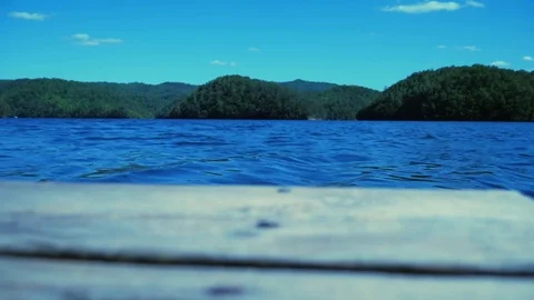 Low angle shot on a dock looking out at a river 스톡 동영상 75598646