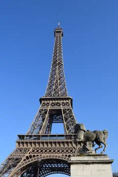 Low angle shot of the Eiffel Tower in Paris, France under a clear blue sky Stock Photos
