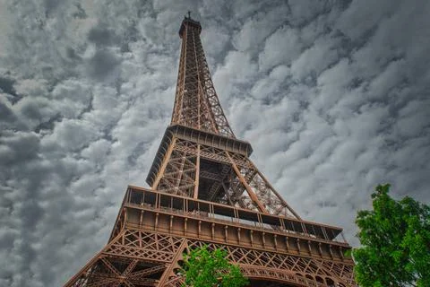 Low angle shot of the Eiffel Tower in Paris, France on a cloudy day Stock Photos