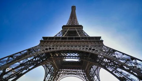 Low angle shot of the Eiffel tower against the bright sky Photos