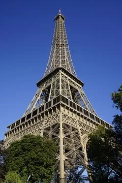 Low-angle shot of the Eiffel tower on the background of blue sky in Paris, Franc Stock Photos