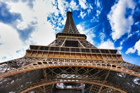 Low angle shot of the Eiffel Tower under a cloudy blue sky, Paris France 스톡 사진