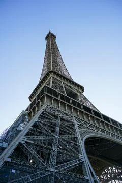 Low angle shot of the Eiffel Tower against a blue sky in Paris, France 写真素材
