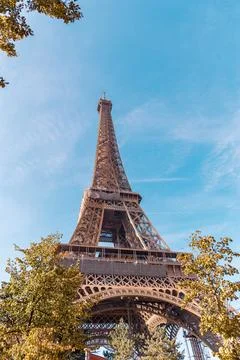 Low angle shot of the Eiffel Tower on a clear sunny afternoon in Paris, France Stock Photos