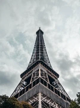Low-angle shot of the Eiffel Tower in Paris, France on a cloudy day Stock Photos