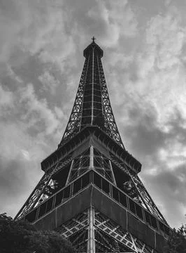 Low-angle shot of the Eiffel Tower in Paris, France on a cloudy day Stock Photos