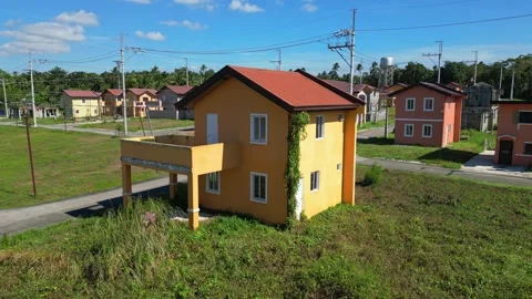 Low-angle shot emphasizing house facades at Camella Homes Alfonso Cavite Vidéo 332925085